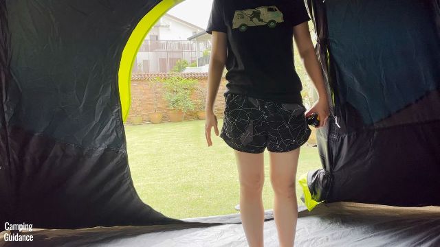 This is a picture of me standing in front of the back door of the Coleman 10-Person Instant Cabin Tent.