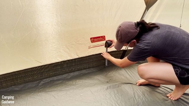 This is a picture of me using a tape measure to measure the height of the bathtub feature of the Coleman WeatherMaster 10-Person Tent (7.5 inches).
