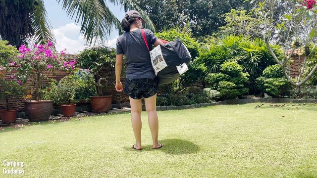 This is a picture of me carrying the WeatherMaster 10-Person Tent using the strap of its carry case.