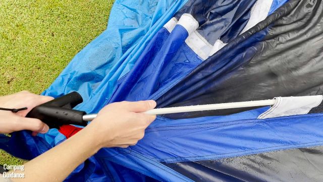 This is a picture of me attaching the fiberglass roof pole of the Columbia Mammoth Creek 10-Person Tent to the respective pole connector.