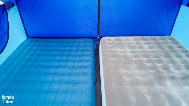 This is a picture of 2 queen sized beds in one room when using the pre-attached room divider of the Columbia Mammoth Creek 10-Person Tent.