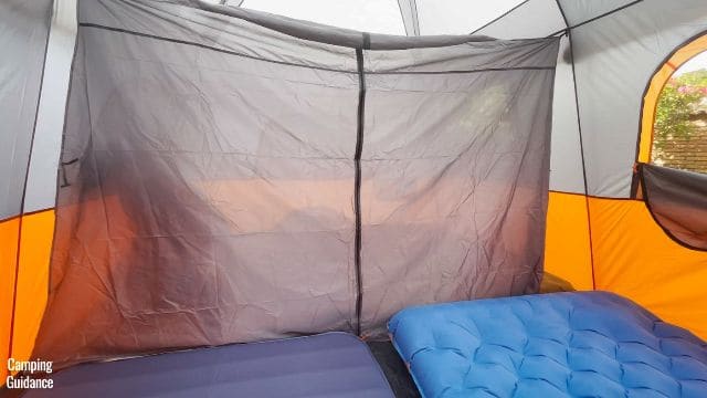 This picture shows that you can fit 2 queen-sized beds into one room if you use the divider of the Core 10-Person Straight Wall Cabin Tent.