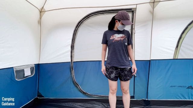 This is a picture of me standing in front of the door of the Ozark Trail 10-Person Family Cabin Tent.