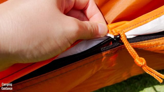 This is a picture of the rain cover of one of the doors snagging on the zipper of the Core 10-Person Straight Wall Cabin Tent.