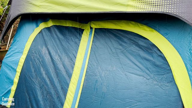 This is a picture of rain dripping off the rainfly of the Coleman 10-Person Instant Cabin Tent and onto the mesh of the doors and windows.