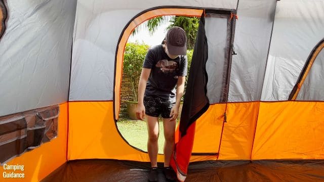 This is a picture of me ducking to get through the door of the Core 10-Person Straight Wall Cabin Tent.