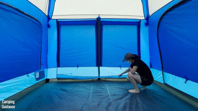 This is a picture of me touching the extra fabric sewn into the Columbia Mammoth Creek Tent's T-door to catch any leaks or water. It's like a little pouch for the door.