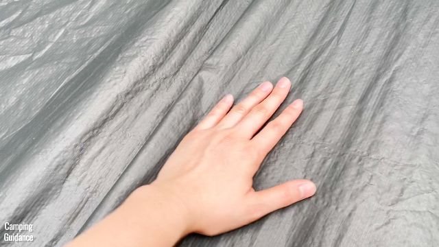 This is a picture of me touching the polyethylene flooring of the WeatherMaster 10-Person Tent.