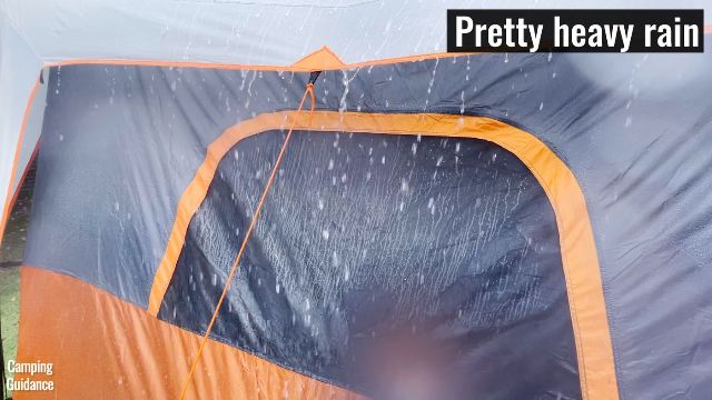 This picture shows that in heavy rain, the mesh of the windows of the Core 10-Person Straight Wall Cabin Tent will be almost completely soaked.