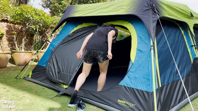 This is a picture of me ducking to get into the tent through the hinged D-door of the Coleman 10-Person Instant Cabin Tent.