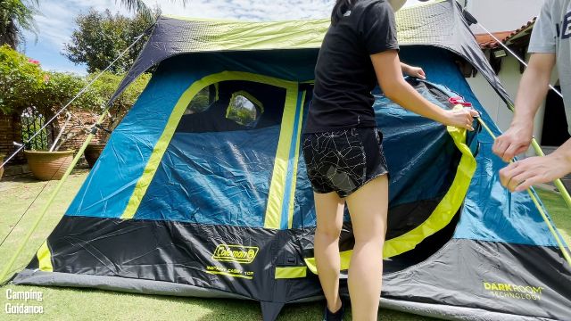 This is a picture of my brother and I setting up the hinged D-door of the Coleman 10-Person Instant Cabin Tent.