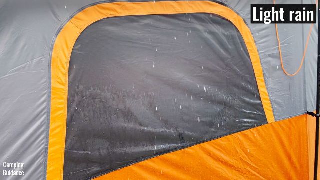 This picture shows that in light rain, quite a bit of water will drip onto the mesh of the windows of the Core 10-Preson Straight Wall Cabin Tent.