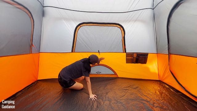 This is a picture of me touching the orange fabric near the ground vent (which felt a bit damp during the rain test).