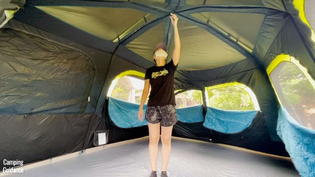 the author standing under the peak height of the Coleman Instant Cabin 10
