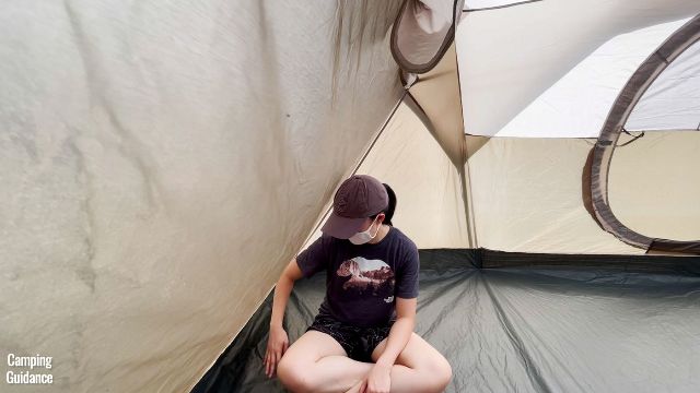 This is a picture of me sitting in the small triangular space at the widths of the Coleman WeatherMaster 10-Person Tent.