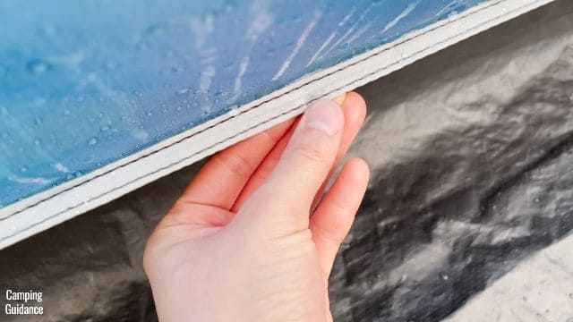 This is a picture of me touching the leaky seam in the Ozark Trail 10-Person Cabin Tent.