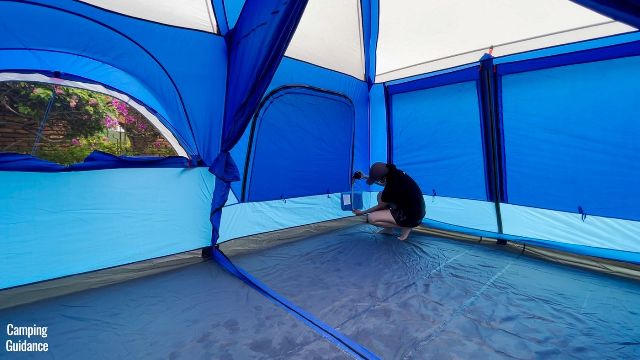 This is a picture of me using a tape measure to get the dimensions of one of the storage pockets of the Columbia Mammoth Creek 10-Person Tent.