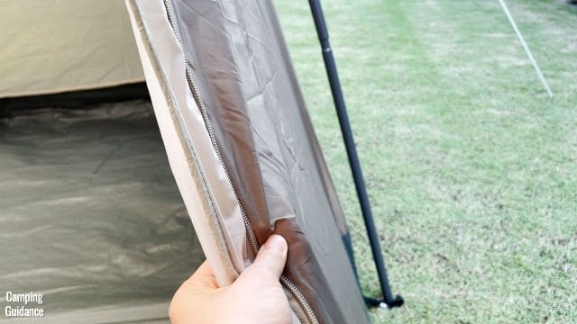 This is a picture of me touching the tent body of the WeatherMaster 10-Person Tent. This is the dark brown fabric of the tent body.