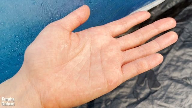 The author's hand wet after touching the walls in the OZark Trail Cabin 10