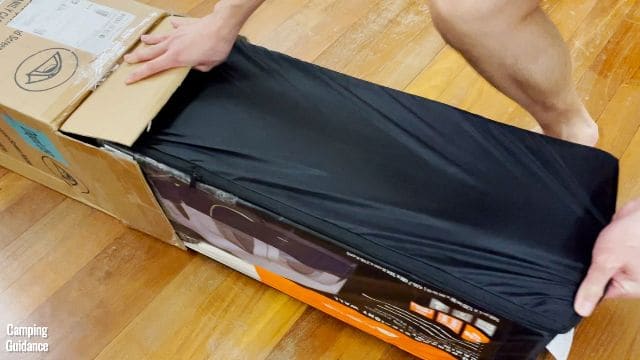The author unboxing the Ozark Trail Cabin 10