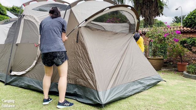 This is a picture of my brother and I installing the fiberglass pole for the angled window of the Coleman WeatherMaster 10-Person Tent.