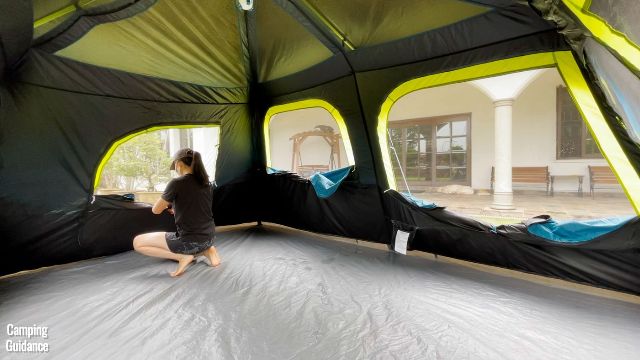 In this picture, you can see the different sized windows of the Coleman 10-Person Instant Cabin Tent, and that’s me in the picture opening up all the windows. (From left to right: mesh of back door, second biggest window, and biggest window).