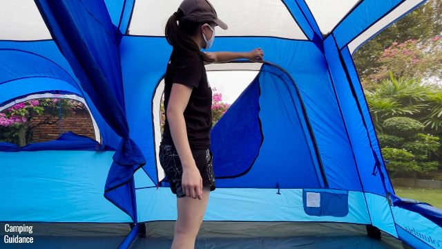 This is a picture of me unzipping the extra-large window of the Columbia Mammoth Creek 10-Person Tent.