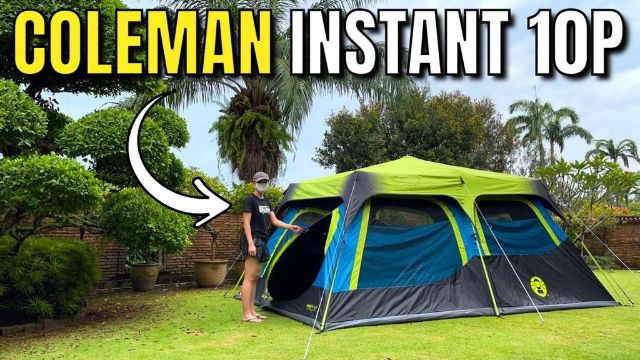 This is a picture of me standing in front of my Coleman 10-Person Dark Room Instant Cabin Tent in my yard.