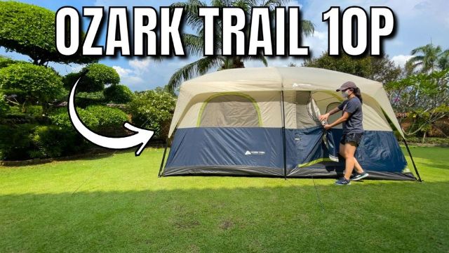 This is a picture of me opening the door to my Ozark Trail 10-Person Cabin Tent in my yard.