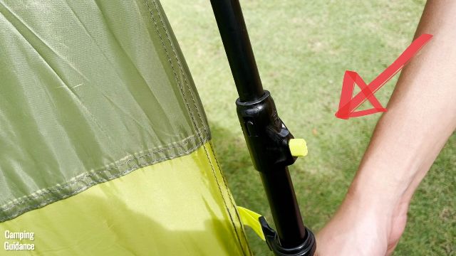 This is the button (light green in color) that has already popped out when I fully extended one of the telescoping wall poles of the Outdoor Products 10-Person Instant Cabin Tent.