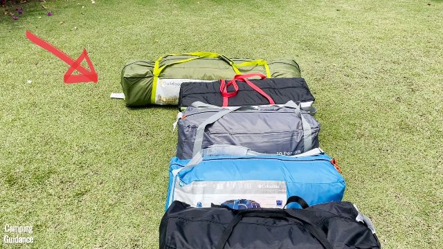 This is a picture of what my Outdoor Products 10-Person Instant Cabin Tent looks like compared to other non-instant traditional 10-person tents for a packed size comparison. The red arrow is pointing to the Outdoor Products Tent.