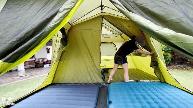 The author unzipping the room divider of the Outdoor Products Instant Cabin 10