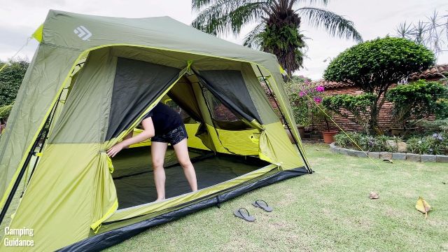 This is a picture of me opening up the T-door of the Outdoor Products 10-Person Instant Cabin Tent.