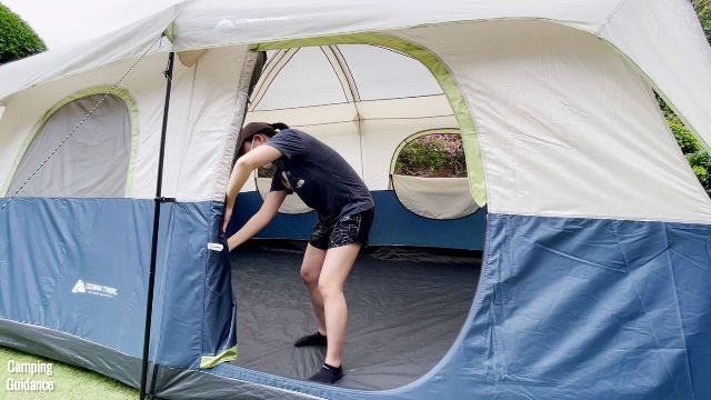 This is a picture of me securing the door to the side using the provided latches/clips of the Ozark Trail 10-Person Cabin Tent.