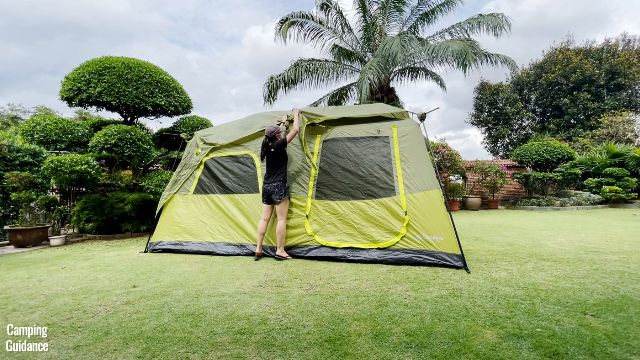 The author setting up the rainfly of the Outdoor Products Instant Cabin 10.