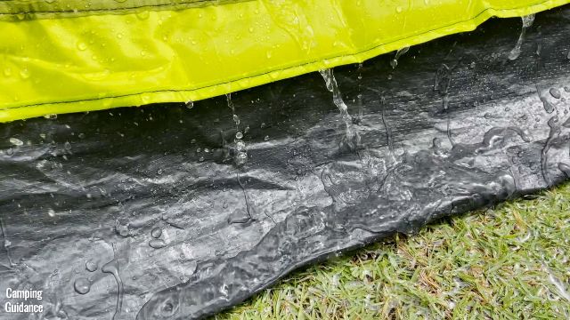 This is a picture of the bathtub flooring of the Outdoor Products 10-Person Instant Cabin Tent from the outside, in the rain.
