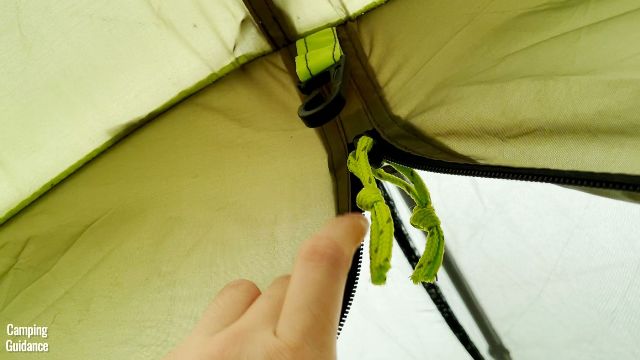 This is a picture of one of the lantern loops near the divider inside the Outdoor Products 10-Person Instant Cabin Tent.