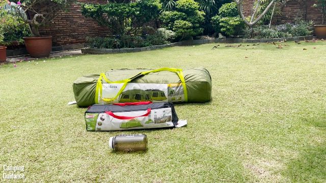 This is what a packed-up Outdoor Products 10-Person Instant Cabin Tent (behind) looks like beside a Coleman 2-Person Sundome Tent (middle) and a 32-ounce Nalgene bottle (front).