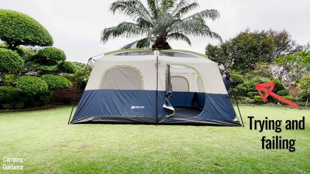 This is a picture of me trying and failing to put the rainfly on the Ozark Trail 10-Person Cabin Tent on my own.