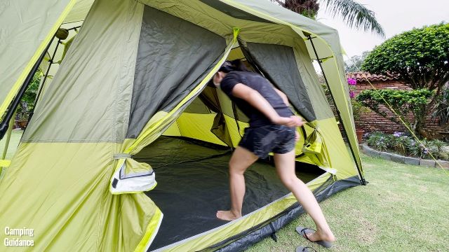 This is a picture of me ducking to get into the Outdoor Products 10-Person Instant Cabin Tent through its T-door.