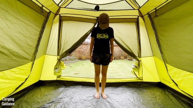This is a picture of me standing in front of the T-door in the Outdoor Products 10-Person Instant Cabin Tent.