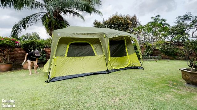 This is a picture of me removing the stakes from the Outdoor Products 10-Person Tent, and the light wind in my yard was already blowing it away.