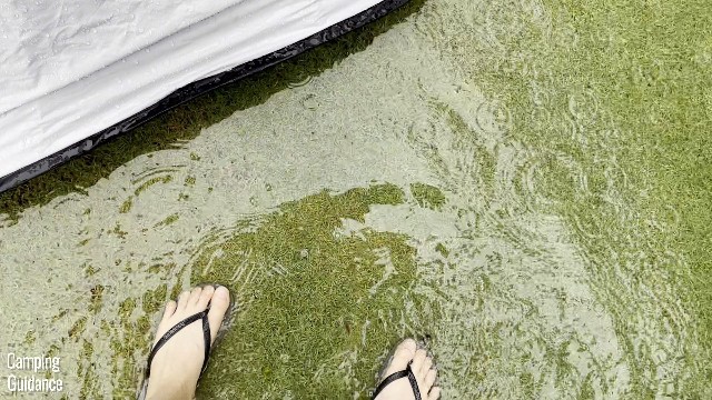 This is a picture of me standing beside my Quechua 2 Seconds Fresh and Black Tent in a slightly flooded yard.