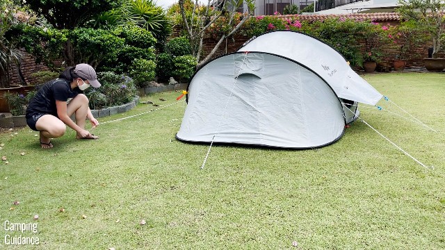 This is a picture of me guying out the 3 guylines at the back of the Quechua 2 Seconds Fresh and Black Tent.