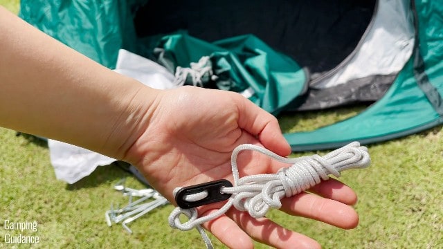 This is what the guylines of the Quechua 2 Seconds Pop Up Tent look like out of the package. They are not pre-attached to the tent body.
