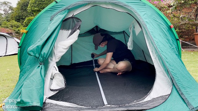 This is a picture of me using a tape measure to measure the base dimensions of the Quechua 2 Seconds Pop Up Tent.