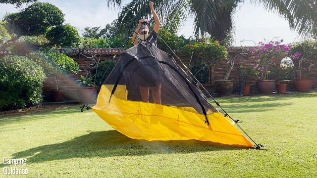 This is a picture of me popping up the Teton Sports 2-Person Vista Quick Tent. Notice I’m using one hand to grab the drawstring of the central hub, and the other hand to press down on the hub.