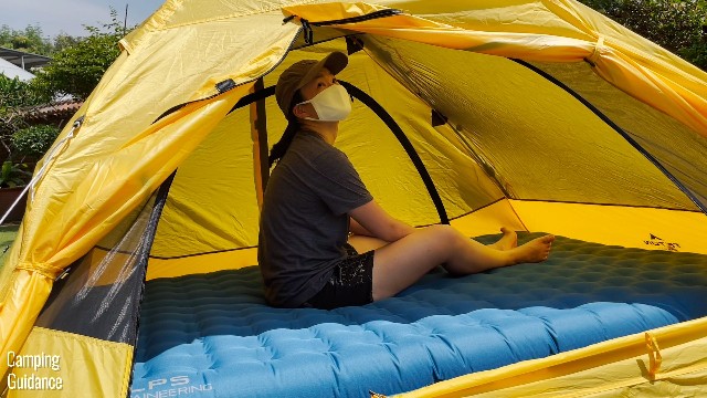 This is a picture of me sitting down on a queen-sized camping mattress inside my Teton Sports 2-Person Vista Quick Tent, with lots of headroom above me. This mattress is 6 inches thick.