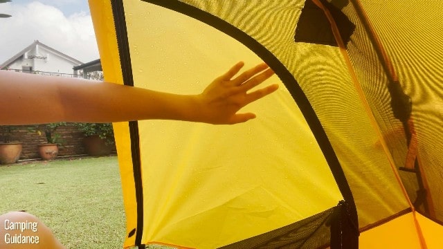 This is a picture of me touching the rainfly of my Teton Sports 1-Person Vista Quick Tent.