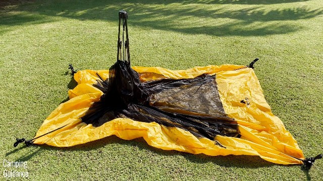 The Teton Sports 2-Person Vista Quick Tent doesn’t pop up immediately when you take it out of the carry case. You’ve got to lay it out flat on the ground like this first, then pop it up using the black hub that’s sticking out.
